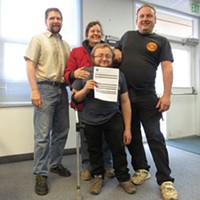 Myles Moscato (center) holds the receipt for his application for a medical marijuana cultivation permit, the first in Humboldt County. He's joined by family members and Interim Director of Planning and Building Rob Wall (left).