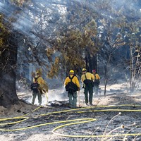 Crews from Cal Fire fight a blaze just north of Stafford on Thursday.