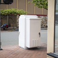 The now white utility box near the corner of Fifth and G streets that once showcased "Cat Food."