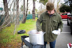 PHOTO BY IRIDIAN CASAREZ - Darrell Burden, a volunteer with the Jefferson Community Center, serving chili to people taking surveys during the Point in Time count on Jan. 23.