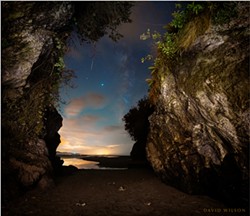 PHOTO BY DAVID WILSON - The cave's mouth opened onto a world of dazzling light and color beneath the cosmos. A shooting star stabbed across the camera's eye. The bright point near its tip is Saturn, while the brightest point is Jupiter. To their right is the Milky Way. Sept. 18, 2020. Moonstone Beach, Humboldt County, California.