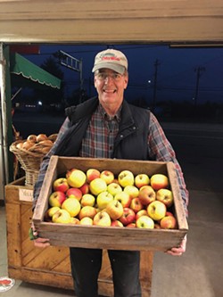 COURTESY OF CLENDENEN'S CIDER WORKS - Cliff Clendenen with his family's apples at Clendenen's Cider Works, which sends fruit to local schools.