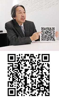 COURTESY OF DENSO WAVE - Masahiro Hara with his invention, the QR code. Scan the code below the photo with your smartphone to read a Very Important Message.