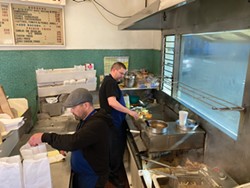 PHOTO BY JENNIFER FUMIKO CAHILL - James Carpenter and Jamie McBride work side by side in the kitchen at Mike's Drive Up.