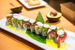 PHOTO BY MARK MCKENNA - The Rock it Roll is made with tempura shrimp and cucumber topped with yellowfin tuna, avocado, jalape&ntilde;os and a citrus aioli, which is seared with a torch and served with herb oil.