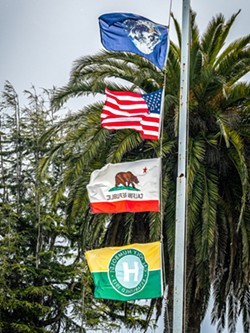PHOTO BY MARK LARSON - Flags at the Arcata Plaza, with the Earth flag atop those representing the United States, California and Cal Poly Humboldt, fly at half-staff March 28 in honor of victims of a school shooting in Tennessee the day before.