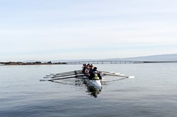 PHOTO BY JEROME SIMONE - An eight-person boat on the water with all oar blades aligned.