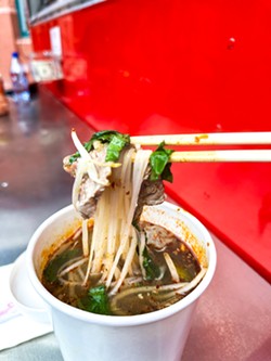 PHOTO BY JENNIFER FUMIKO CAHILL - Nou Nou's ribeye ph&ocirc; special in a plastic-lined paper container at Friday Night Market in Old Town.