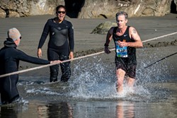 PHOTO BY MARK LARSON - Former Humboldt State University All American Chuck Mullane, of Sunnyvale, arrived first at the Little River water crossing  but finished in second place overall in the Trinidad to Clam Beach Run for the second year in a row at age 54. He did place first in the 50-59 age group with a time of 33:54.