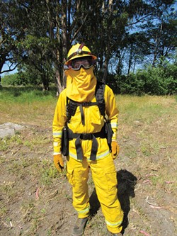 PHOTO BY LINDA STANSBERRY - CalFire firefighter Chris Lanza poses in the protective gear he'll wear on the fireline.