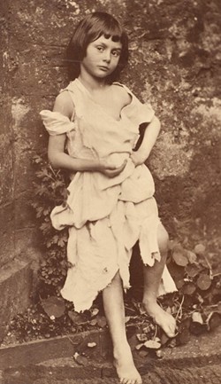 METROPOLITAN MUSEUM OF ART, GILMAN COLLECTION. PUBLIC DOMAIN - Charles Dodgson (aka Lewis Carroll) took this collodion photograph of Alice Liddell, dressed as Tennyson's "Beggar Maid," in her parents' Oxford garden in early June, 1857.
