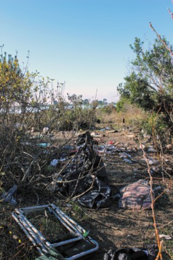 PHOTO BY THADEUS GREENSON - The debris left in the south end of the Palco Marsh after campers were pushed north.
