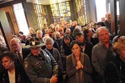 PHOTO BY MARK MCKENNA - Dozens of mourners fill the foyer during the funeral mass for slain Catholic pastor Eric Freed at Sacred Heart Church.