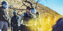 PHOTO BY ROB WILSON - Police use pepper spray on peaceful protesters on the bank of the Cannon Ball River in North Dakota.