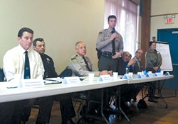 PHOTO BY GRANT SCOTT-GOFORTH - Undersheriff Bill Honsal (standing) responds to a community member's question at the feb. 26 meeting.