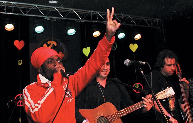 Winstrong, a reggae singer from Suriname, shows the peace sign while performing with the Berel Alexander Ensemble       at Increase       the Peace.
