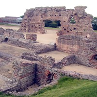 Wroxeter, near present-day Shrewsbury. Although the basilica of the Roman baths fell into disuse around 350 CE, a later phase of large wooden buildings with classical facades was constructed around 480, demonstrating a high level of civilization.